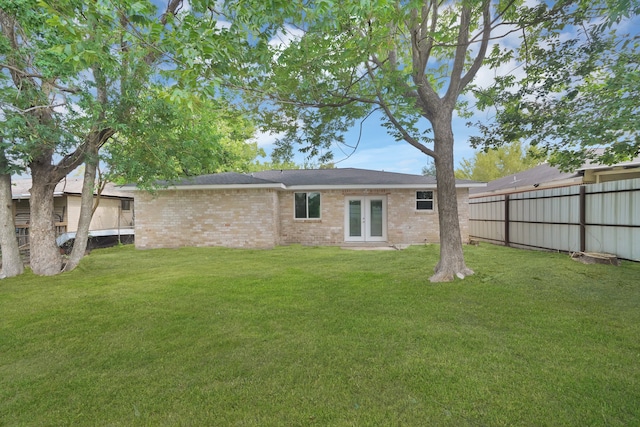 back of house with a lawn