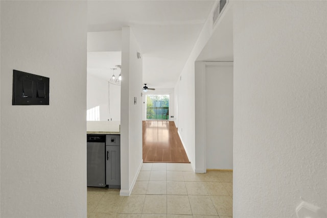 hallway featuring electric panel and light tile patterned floors