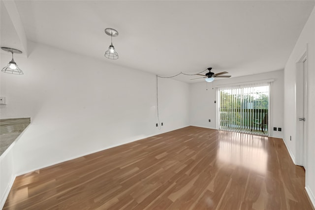 unfurnished living room with hardwood / wood-style flooring and ceiling fan