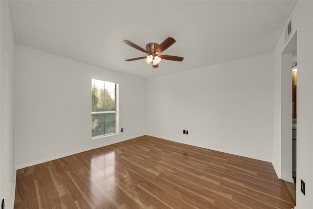 unfurnished room with hardwood / wood-style flooring and ceiling fan