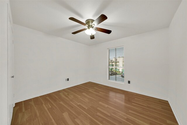 unfurnished room featuring hardwood / wood-style flooring and ceiling fan