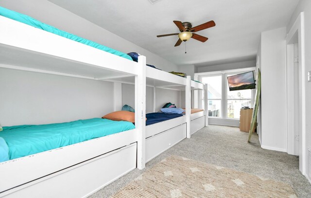 bedroom with light carpet and ceiling fan