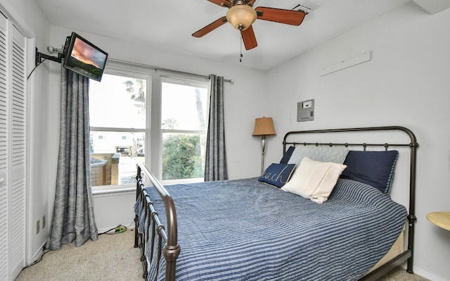 carpeted bedroom featuring a closet and ceiling fan