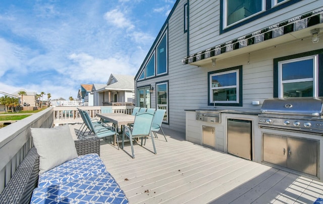 deck featuring area for grilling and a grill