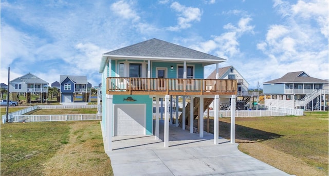 rear view of house featuring a carport, a lawn, a porch, and a garage