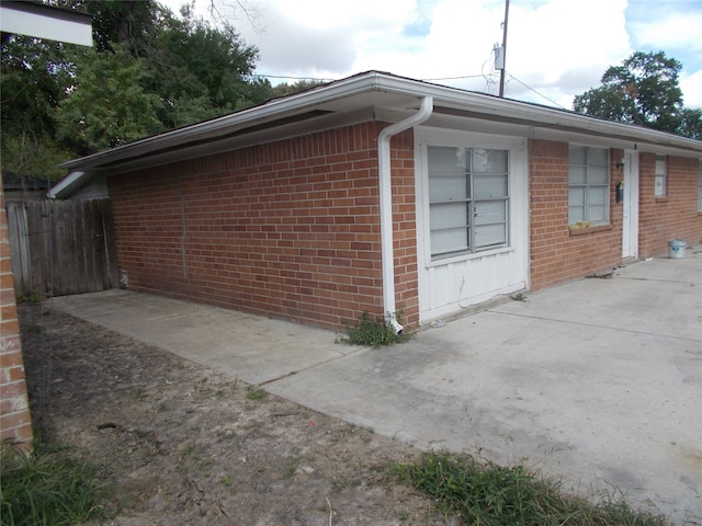 view of side of property with a patio area