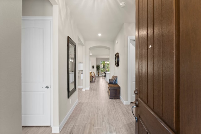 corridor with light hardwood / wood-style flooring