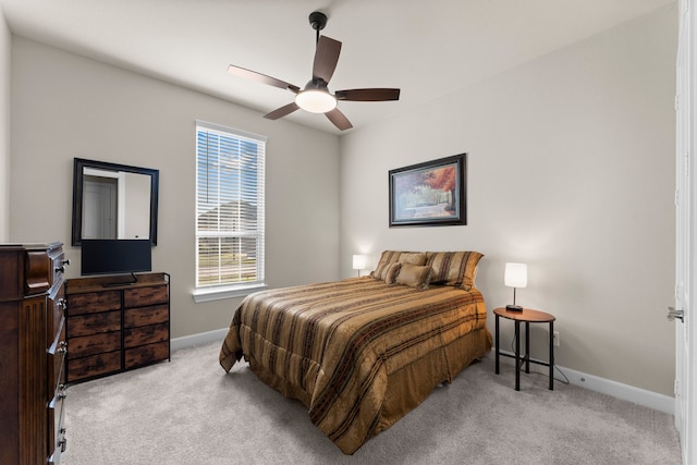 bedroom with ceiling fan and light colored carpet