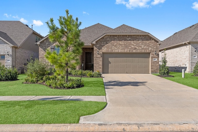 view of front facade with a garage and a front lawn