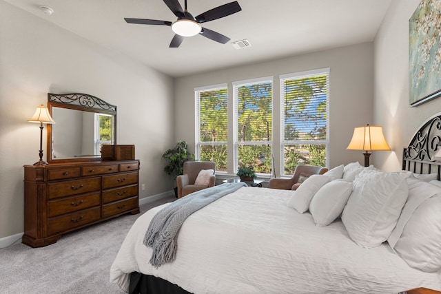 bedroom with ceiling fan and light carpet