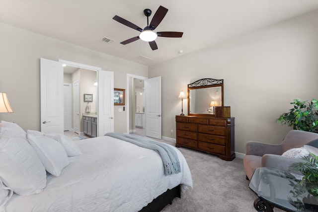 carpeted bedroom with ceiling fan and ensuite bathroom