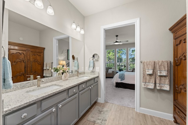 bathroom with hardwood / wood-style floors, vanity, and ceiling fan