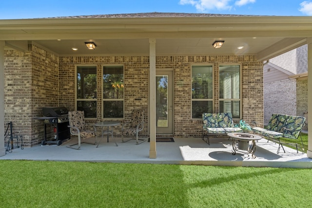 view of patio featuring grilling area and an outdoor living space with a fire pit