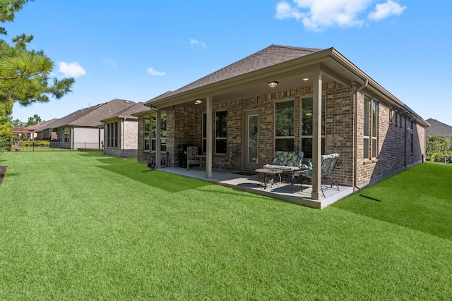 rear view of house featuring a yard and a patio