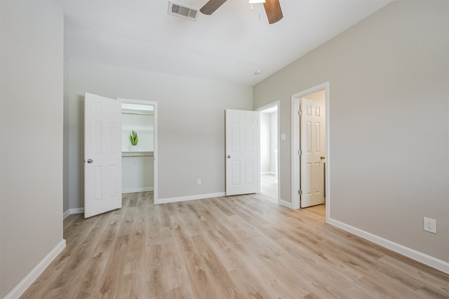 unfurnished bedroom featuring light wood-type flooring, a closet, and ceiling fan