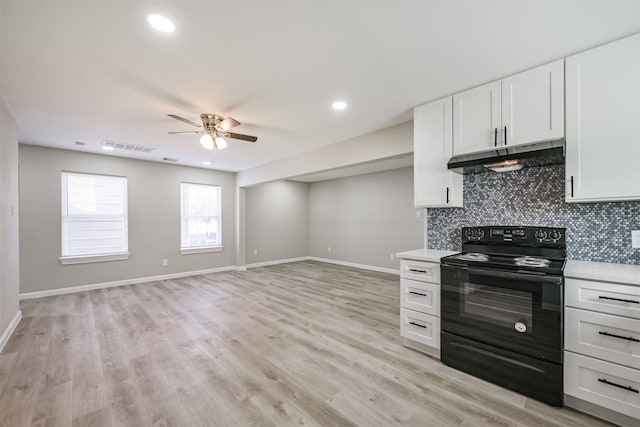 kitchen featuring electric range, ceiling fan, tasteful backsplash, light hardwood / wood-style flooring, and white cabinets