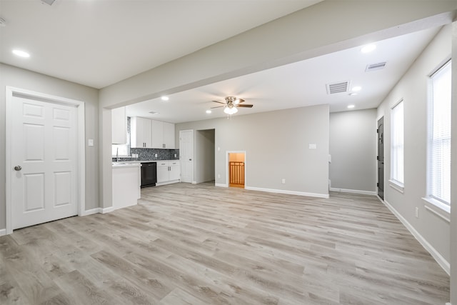 unfurnished living room featuring ceiling fan and light wood-type flooring