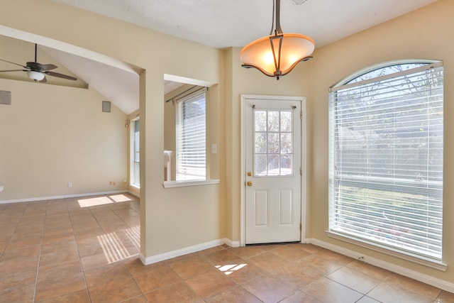 tiled entryway with lofted ceiling and ceiling fan