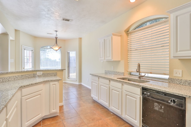 kitchen with black dishwasher, sink, light stone counters, and decorative light fixtures