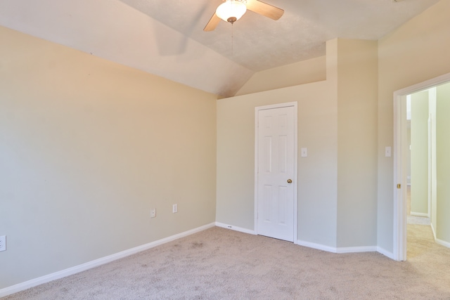 unfurnished room with lofted ceiling and light colored carpet