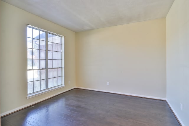 unfurnished room featuring dark wood-type flooring