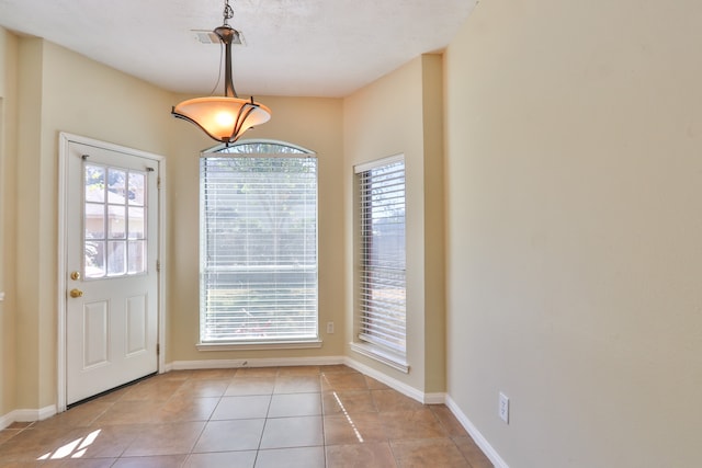 entryway with light tile patterned floors