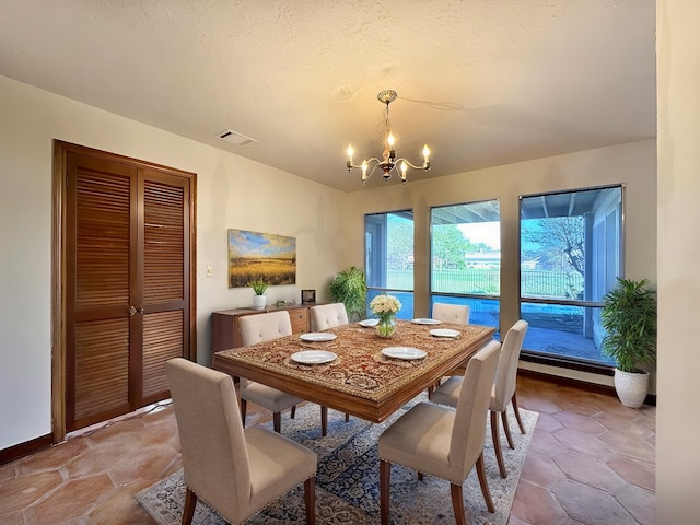 dining space with a chandelier