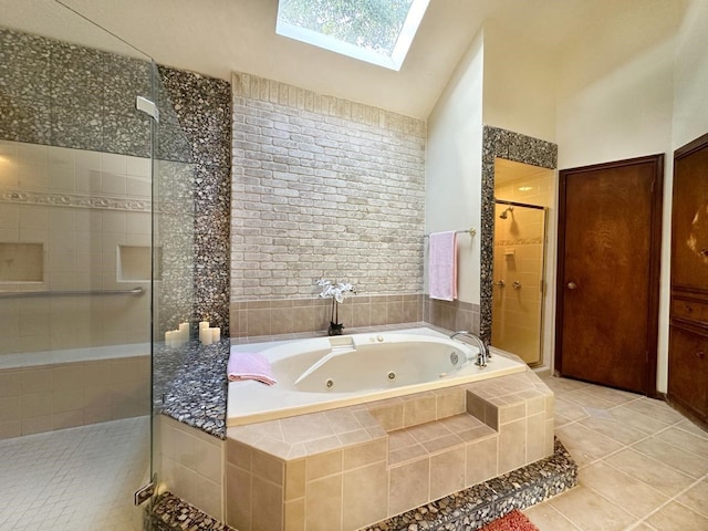 bathroom with tile patterned flooring, independent shower and bath, and vaulted ceiling with skylight