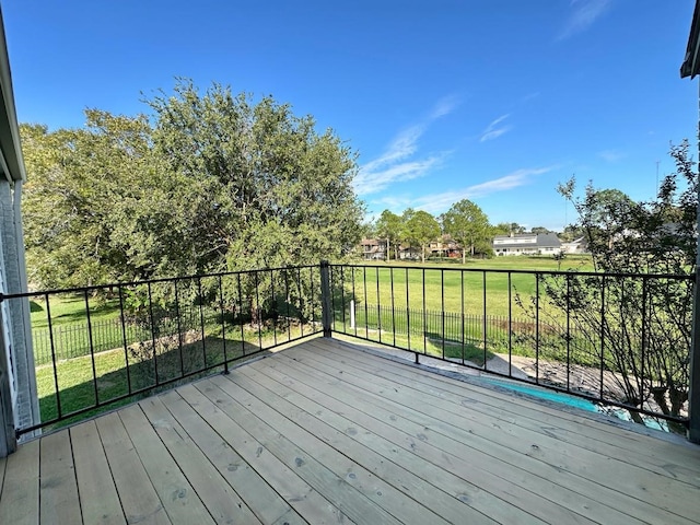 wooden terrace featuring a lawn