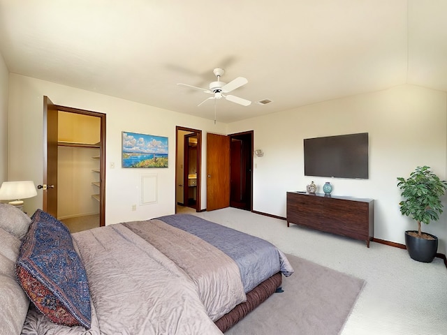 bedroom with carpet flooring, ceiling fan, a walk in closet, and a closet