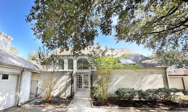 view of front of property with a garage and french doors