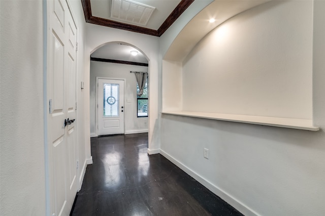 entrance foyer with dark hardwood / wood-style flooring and crown molding