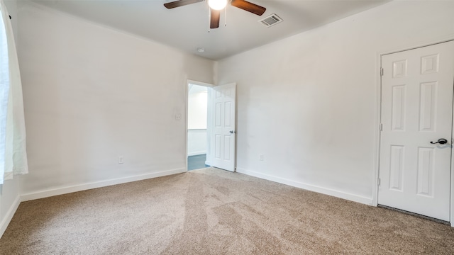 spare room featuring ceiling fan and carpet