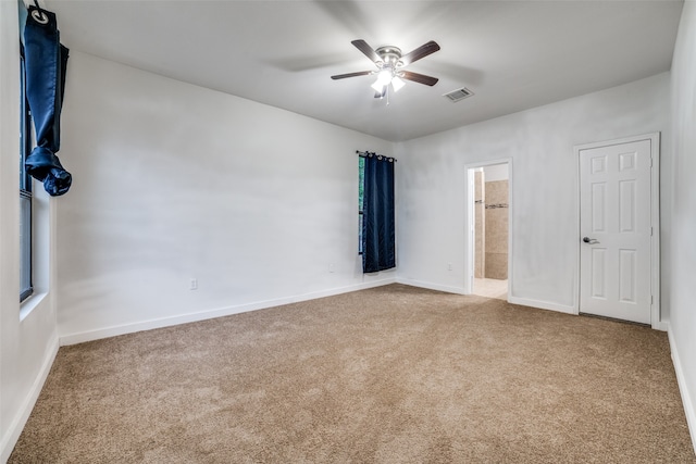 unfurnished bedroom with connected bathroom, ceiling fan, and carpet floors