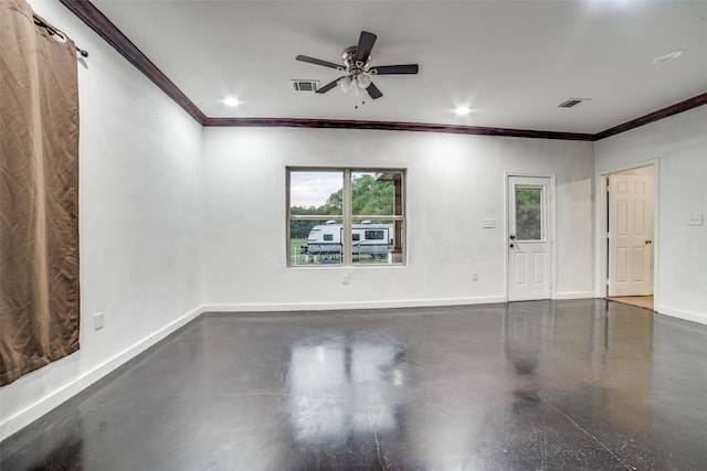 empty room with a barn door, ceiling fan, and ornamental molding