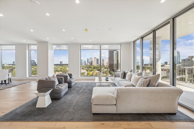 living room with expansive windows, hardwood / wood-style floors, and a wealth of natural light