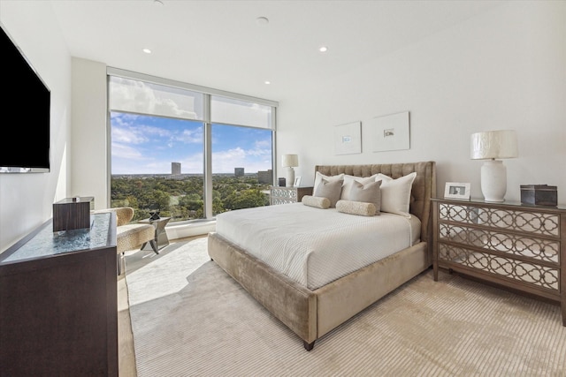 bedroom with recessed lighting and expansive windows