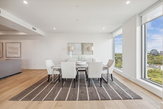 dining room featuring baseboards, recessed lighting, and wood finished floors
