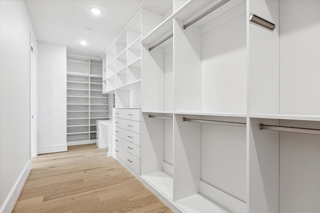 spacious closet with light hardwood / wood-style floors