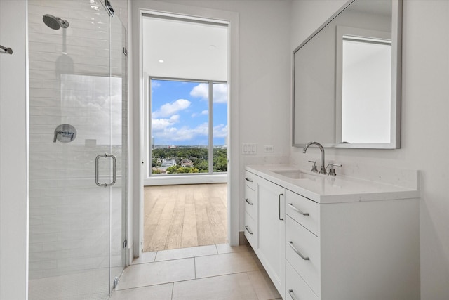 bathroom featuring vanity, tile patterned floors, and a shower stall