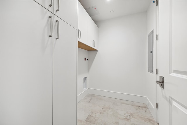 laundry room with electric panel and cabinets