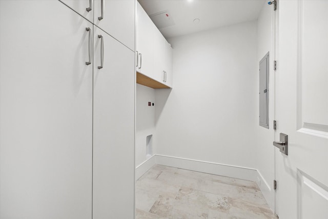 washroom featuring baseboards, electric panel, cabinet space, and marble finish floor