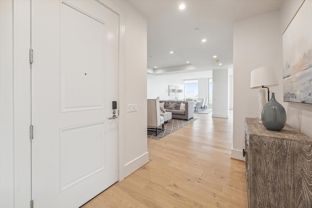 corridor with recessed lighting, baseboards, and light wood finished floors