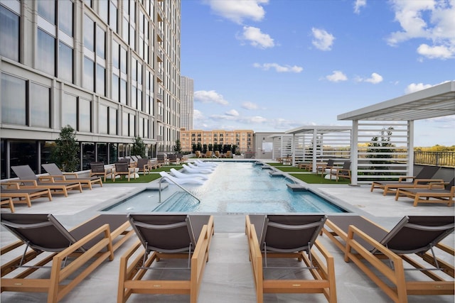 community pool with a patio and an outdoor hangout area
