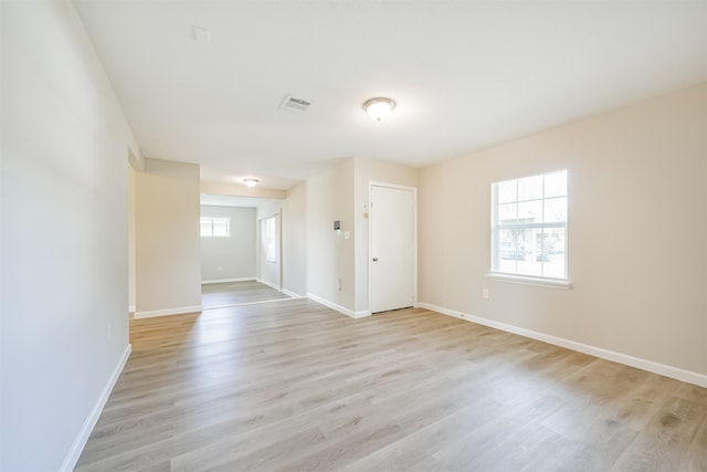 spare room with light wood-type flooring