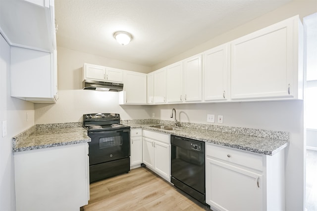 kitchen featuring black appliances, white cabinetry, and light hardwood / wood-style floors