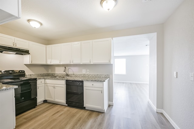 kitchen featuring white cabinets, black appliances, and light wood-type flooring