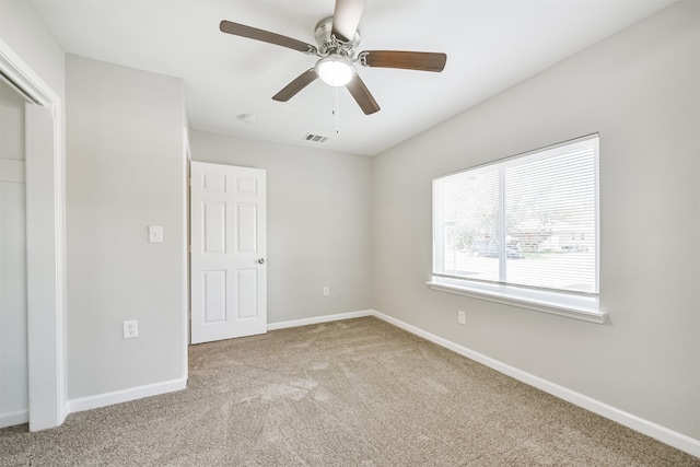 unfurnished bedroom featuring ceiling fan and carpet