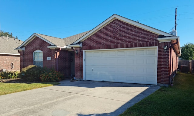 ranch-style house featuring a garage and central AC