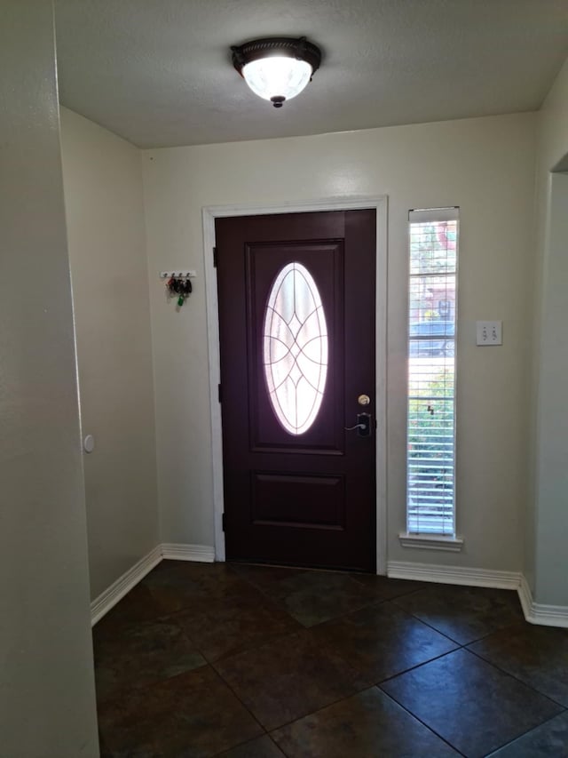 19626 Tularosa Ln, Tomball, TX 77377 - foyer entrance with baseboards and dark tile patterned flooring